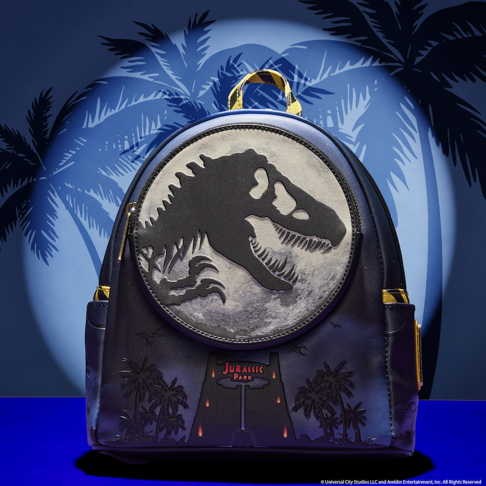 Blue backpack with the gates to Jurassic Park underneath a moon with the shadow of a T-Rex on it. 